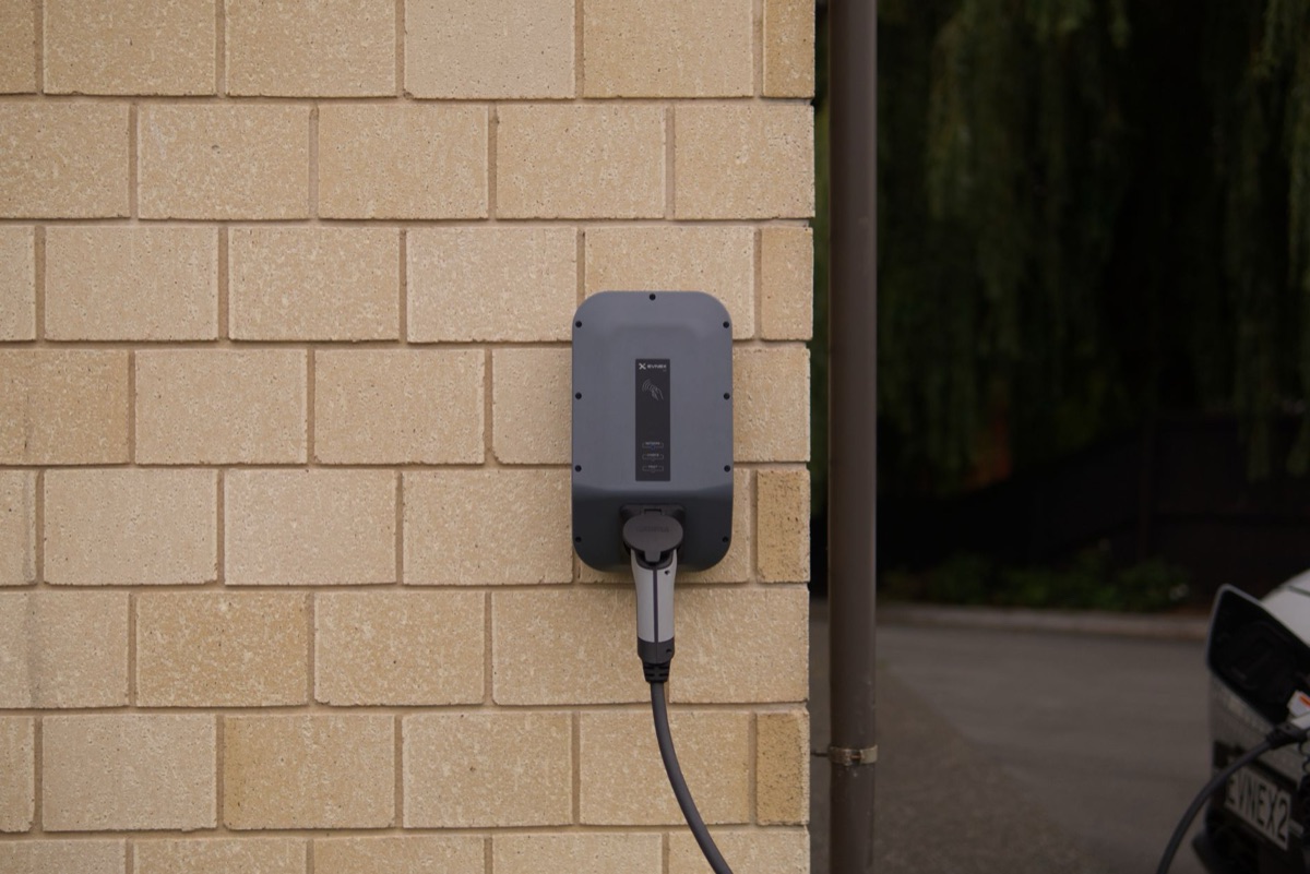 Eine Wallbox für die Heimladung an einer Garagenwand.