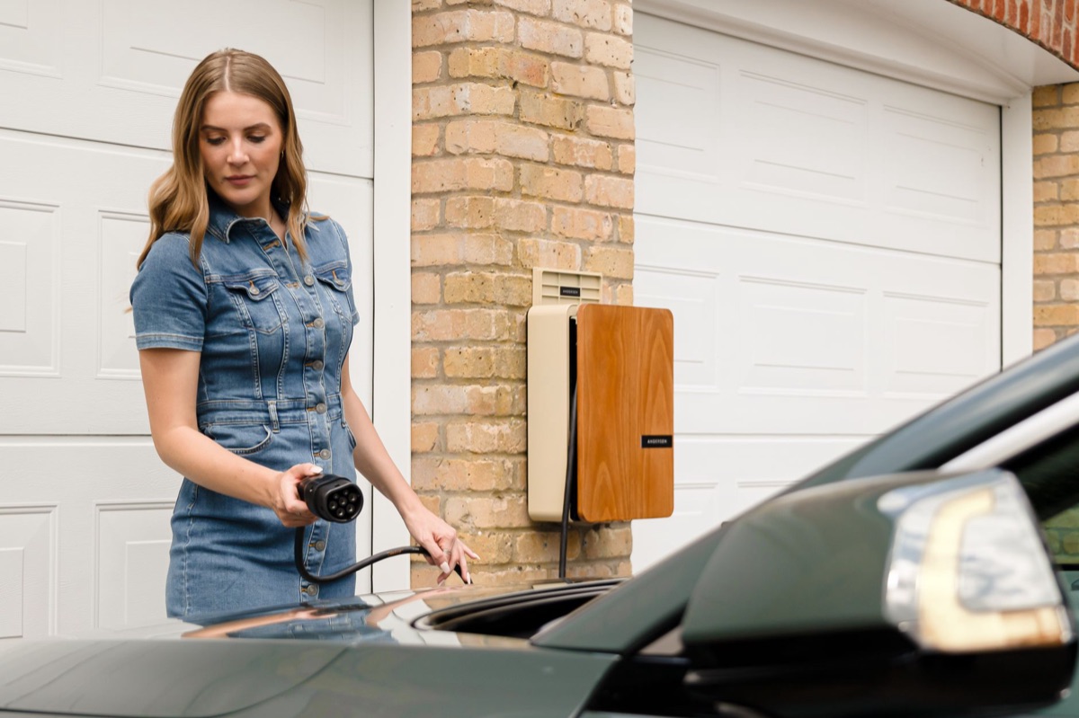 A wall-mounted home EV charging station installed in a modern garage.