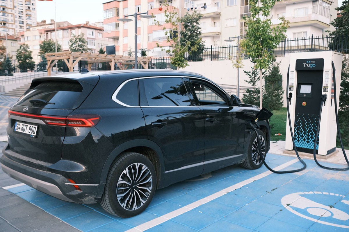 An electric SUV parked at a modern charging station.